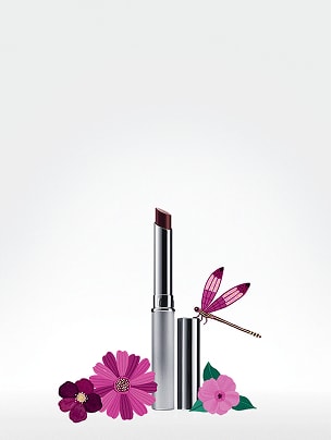 foundation, mascara, and honey lipstick aligned with flowers around 